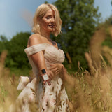 Holly Willoughby with a bottle of her perfume in a garden